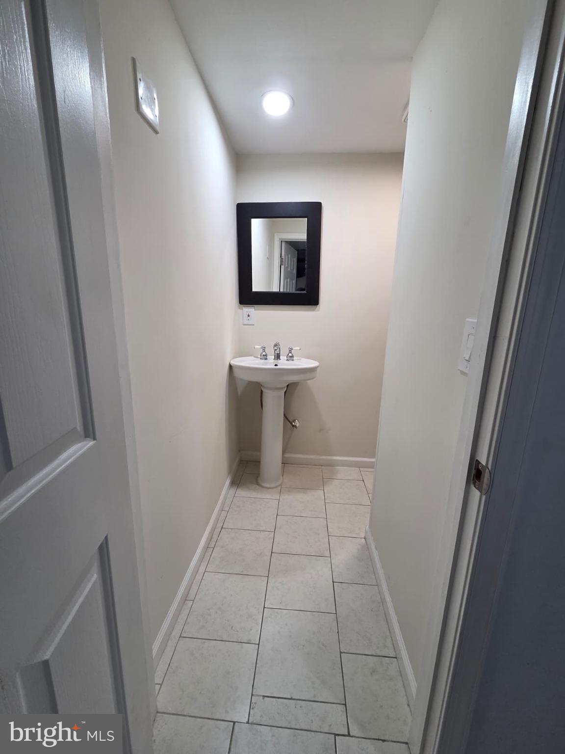 1930 Frames Road Dundalk, MD 21222 - Photo 21 of 30 a bathroom with a sink and mirror