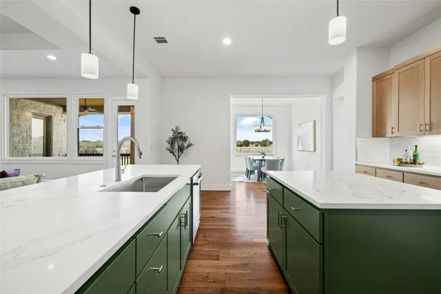 a large kitchen with kitchen island a sink appliances and a counter space