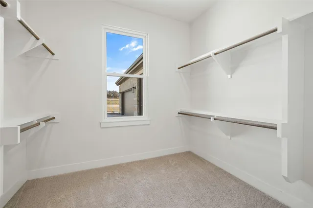 a bedroom with bed and a potted plant