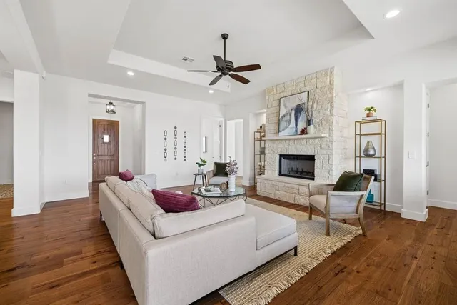 a living room with furniture fireplace and wooden floor