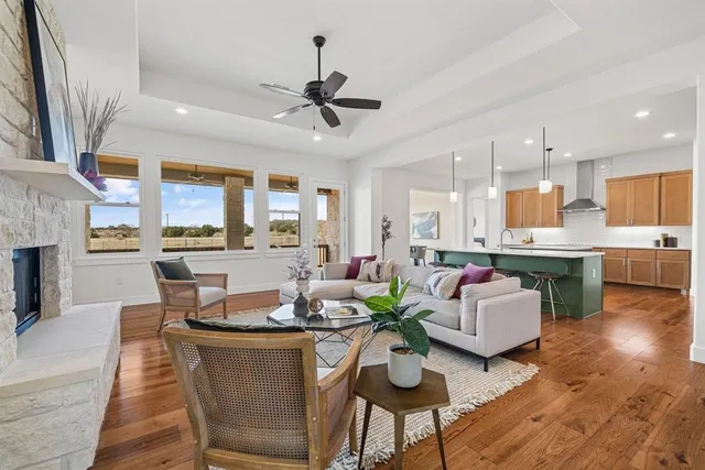 a dining room with furniture a kitchen view and a chandelier