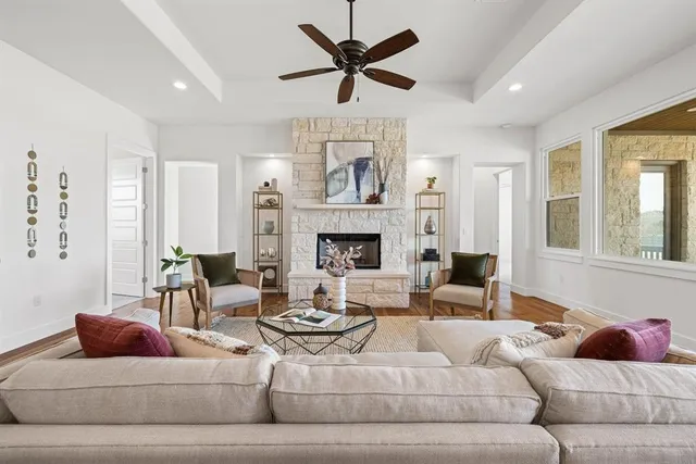 a living room with furniture fireplace and a large window