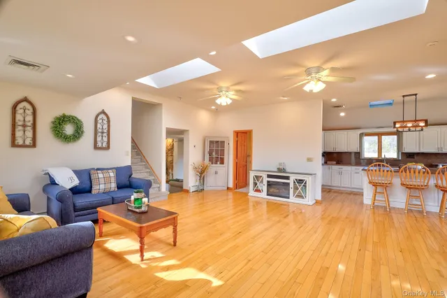 a living room with furniture and kitchen view