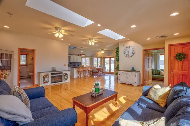 a living room with furniture and kitchen view