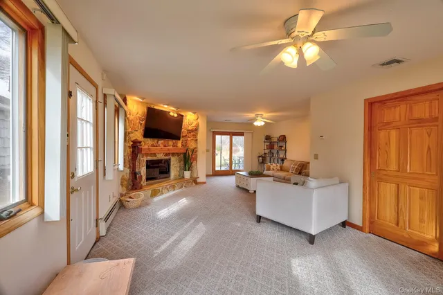 a living room with fireplace furniture and a flat screen tv