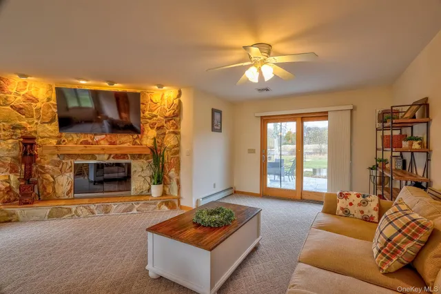 a living room with furniture a flat screen tv and a fireplace