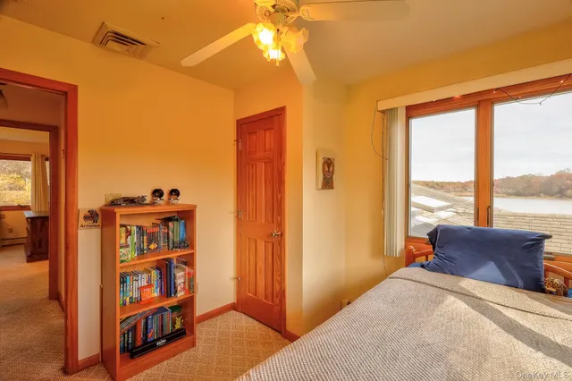 a view of a bedroom with furniture and window