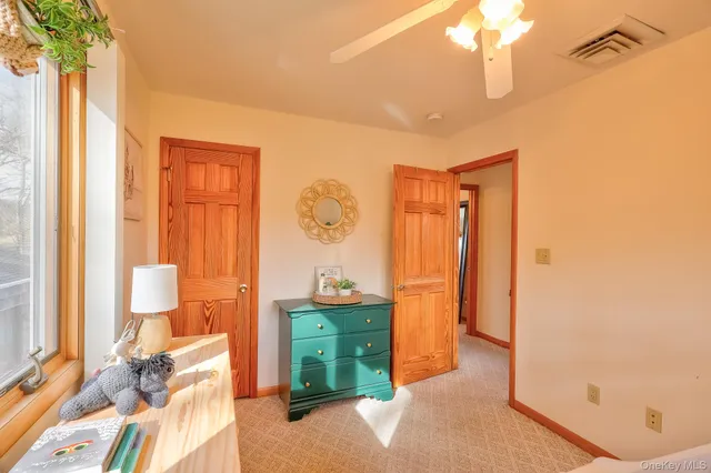 a bedroom with a bed and a mirror