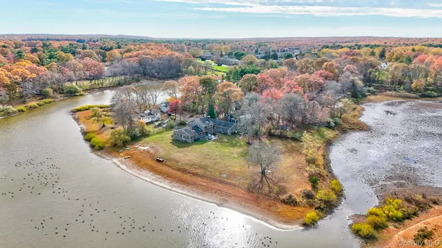 an aerial view of a house with a lake view
