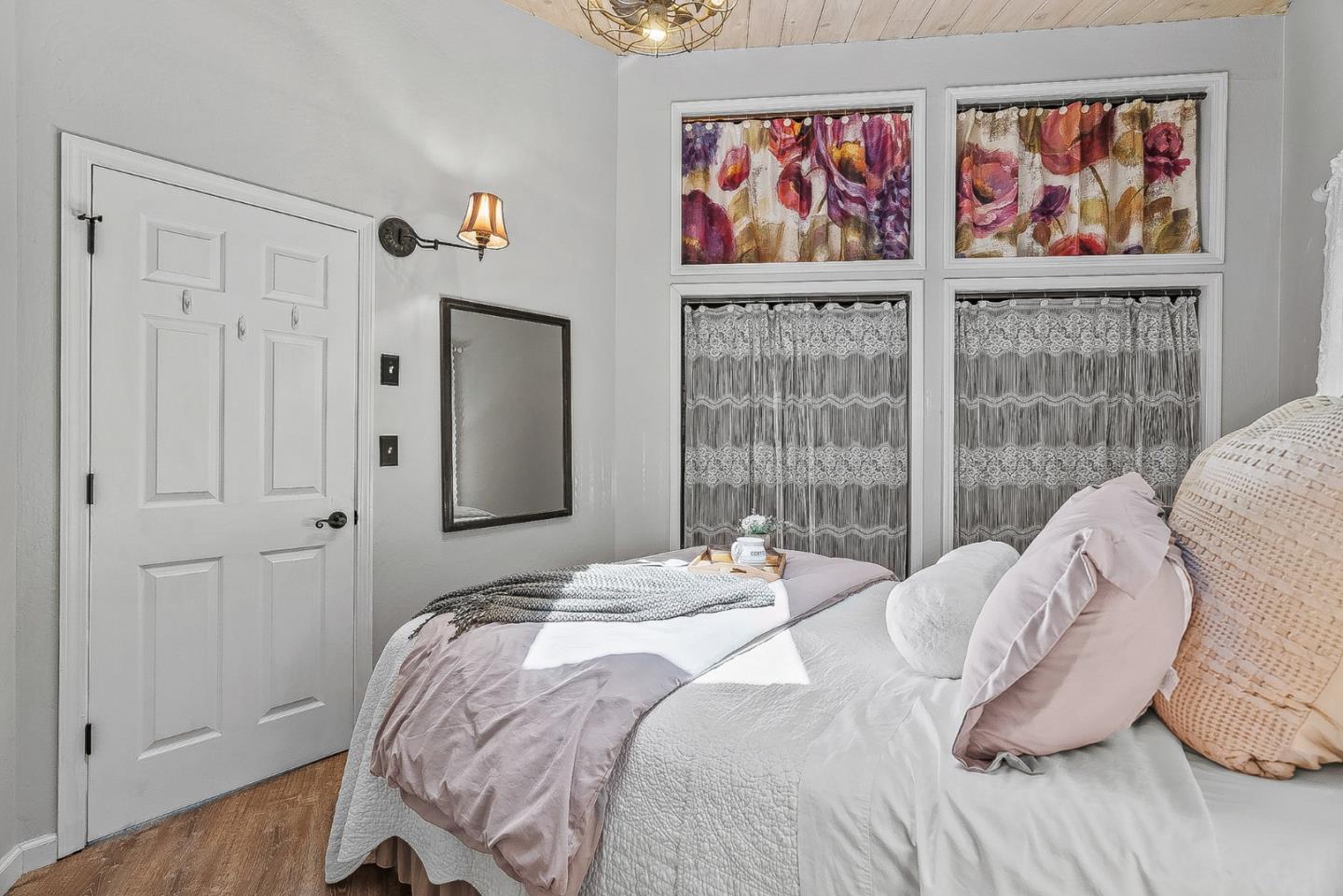 769 Cathedral Drive Aptos, CA 95003 - Photo 17 of 41 a bedroom with a bed and a painting on the wall