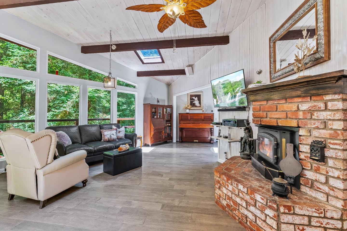 769 Cathedral Drive Aptos, CA 95003 - Photo 4 of 41 a living room with furniture a fireplace and a floor to ceiling window