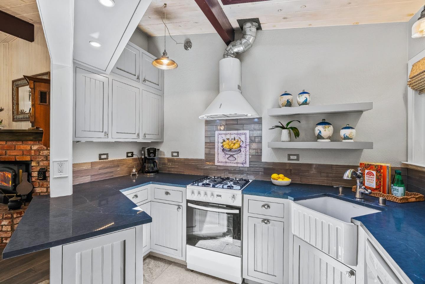 769 Cathedral Drive Aptos, CA 95003 - Photo 6 of 41 a kitchen with a stove a white cabinets and wooden floor