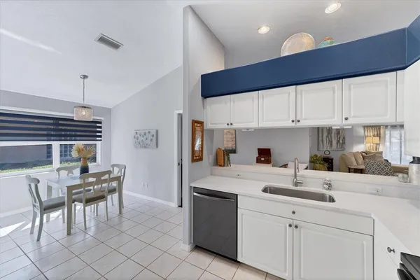 a kitchen with a sink a counter space appliances and cabinets