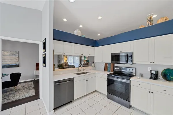 a kitchen with a sink stainless steel appliances and cabinets