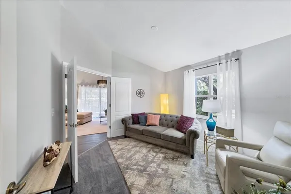 a living room with furniture and a large window