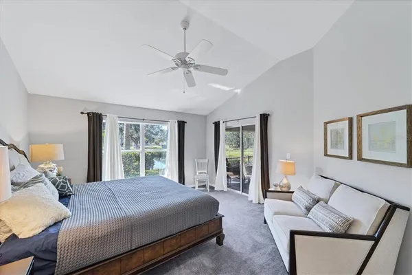a bedroom with a large bed and a couch