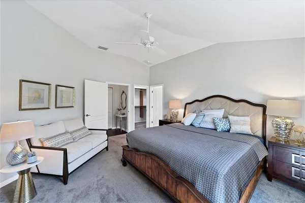 a bedroom with bed and a lamp with wooden floor