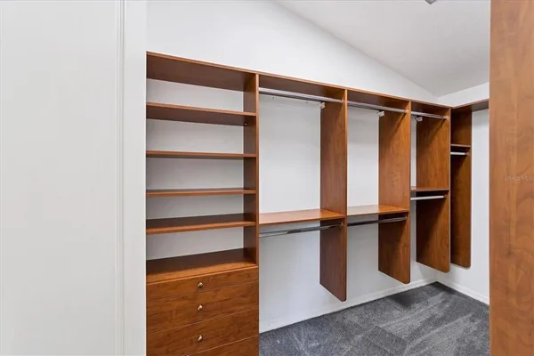 a view of walk in closet with empty racks