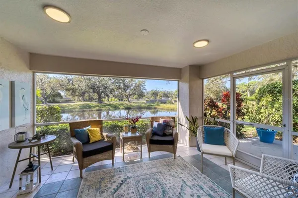 a living room with furniture and a floor to ceiling window
