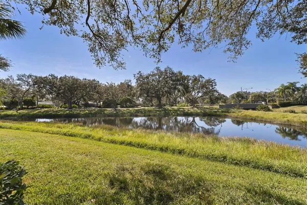 a view of a lake with houses in the back