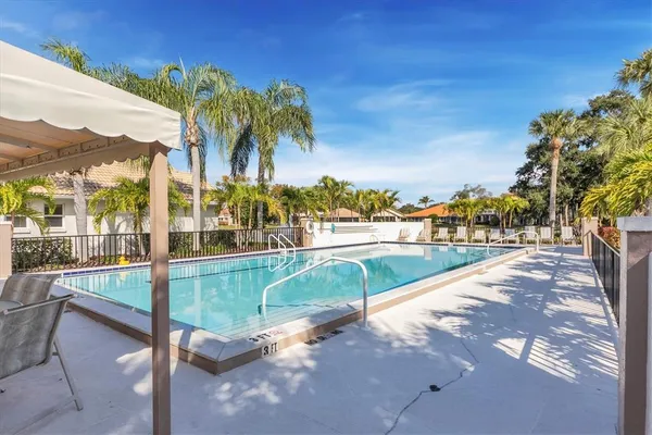 a view of swimming pool with outdoor seating and city view