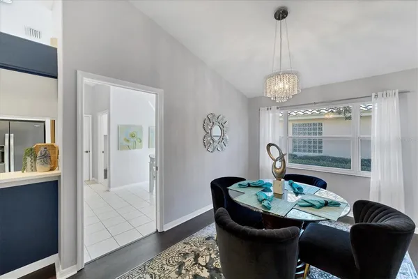 a view of a dining room with furniture and chandelier