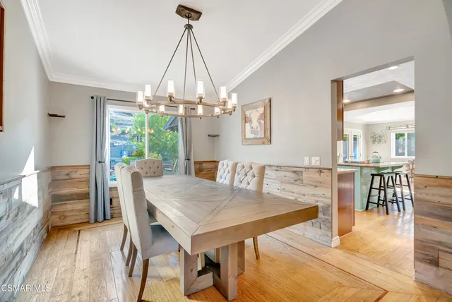 a kitchen with kitchen island granite countertop wooden cabinets a counter top space a sink and stainless steel appliances