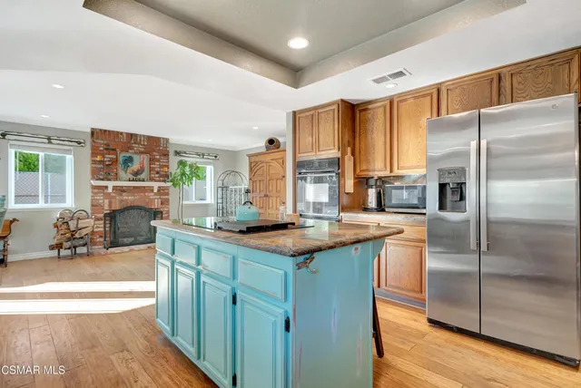 a kitchen with granite countertop wooden cabinets a sink and a window