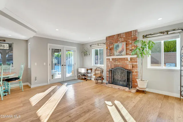 a living room with fireplace furniture and a window