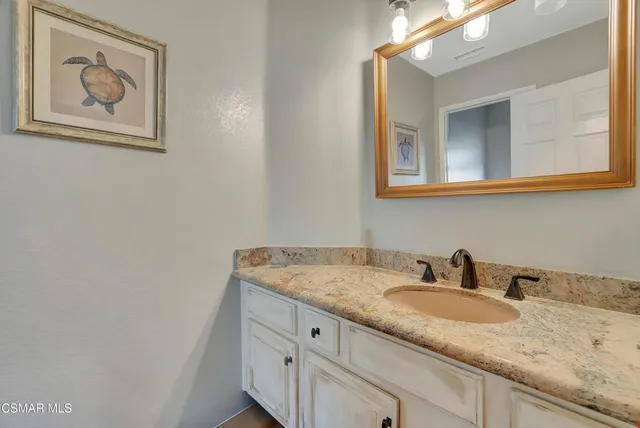 a view of a kitchen with refrigerator and wooden floor