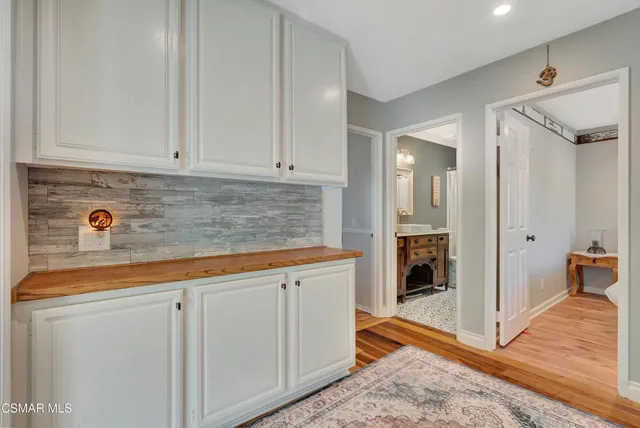 a spacious bedroom with a bed a chandelier and a window