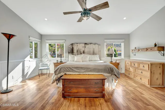 a spacious bathroom with a double vanity sink a mirror and a bathtub
