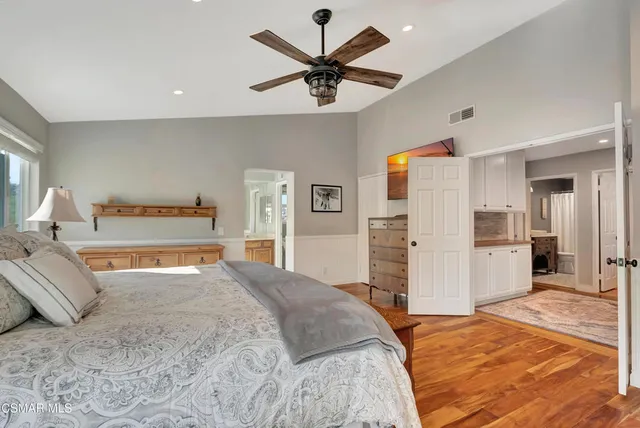 a spacious bathroom with a bathtub sink and mirror