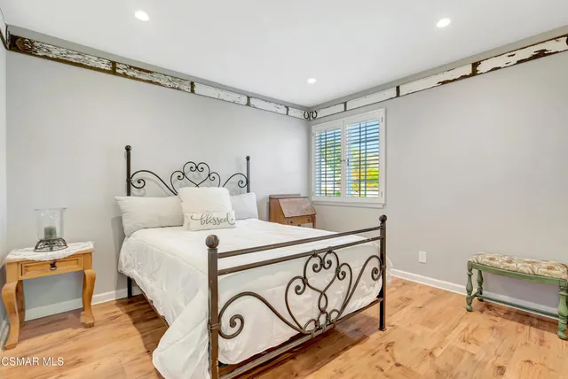 a front view of a house with swimming pool and sitting area