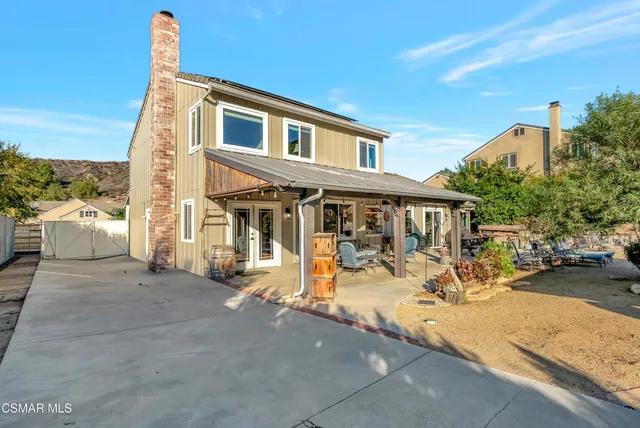a view of an empty room with wooden floor and door