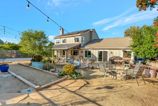 an aerial view of a house with a yard basket ball court and outdoor seating