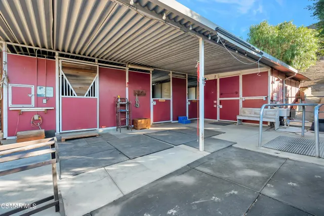 an aerial view of a house with a yard and trees in the back
