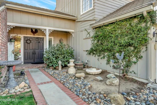 a view of a backyard with table and chairs and potted plants