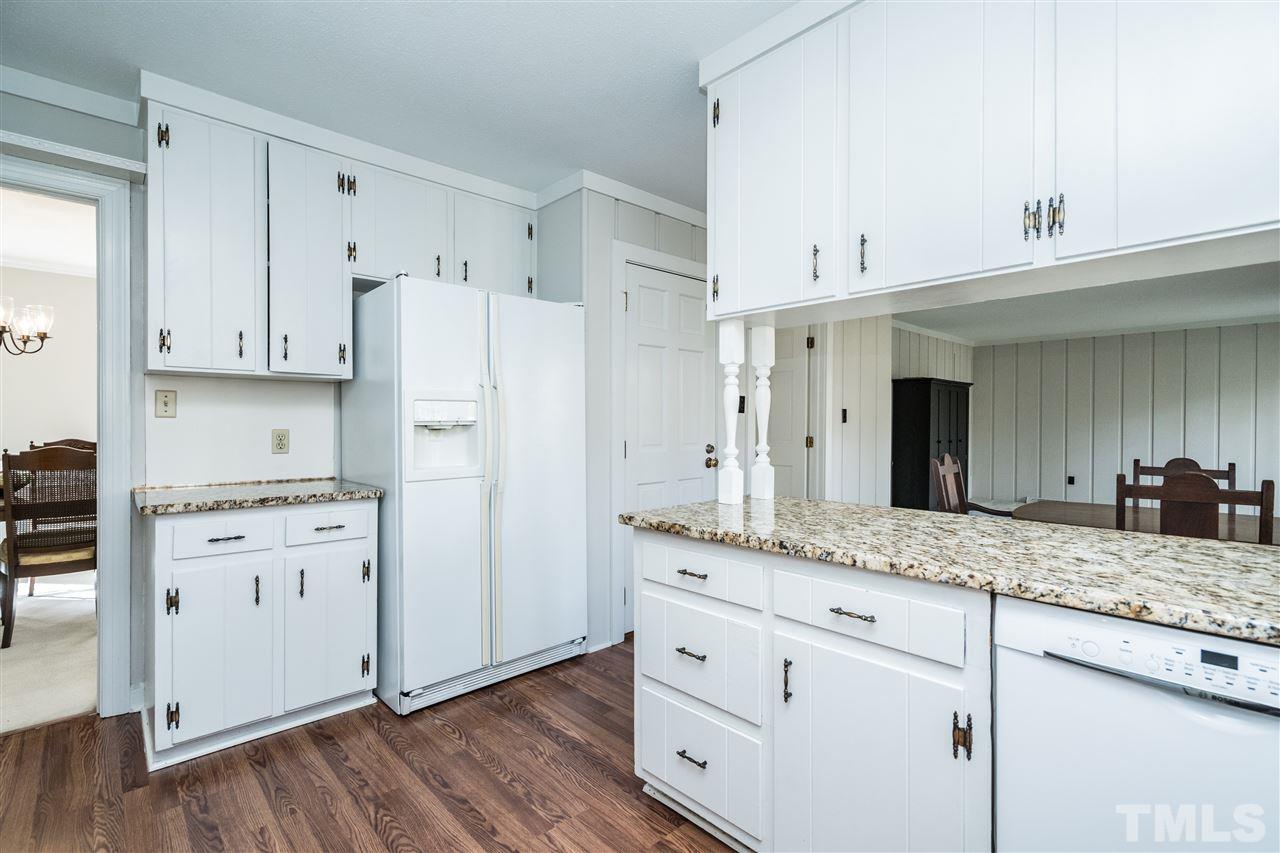 4516 Connell Drive Raleigh, NC 27612 - Photo 12 of 28 a kitchen with granite countertop cabinets and a refrigerator