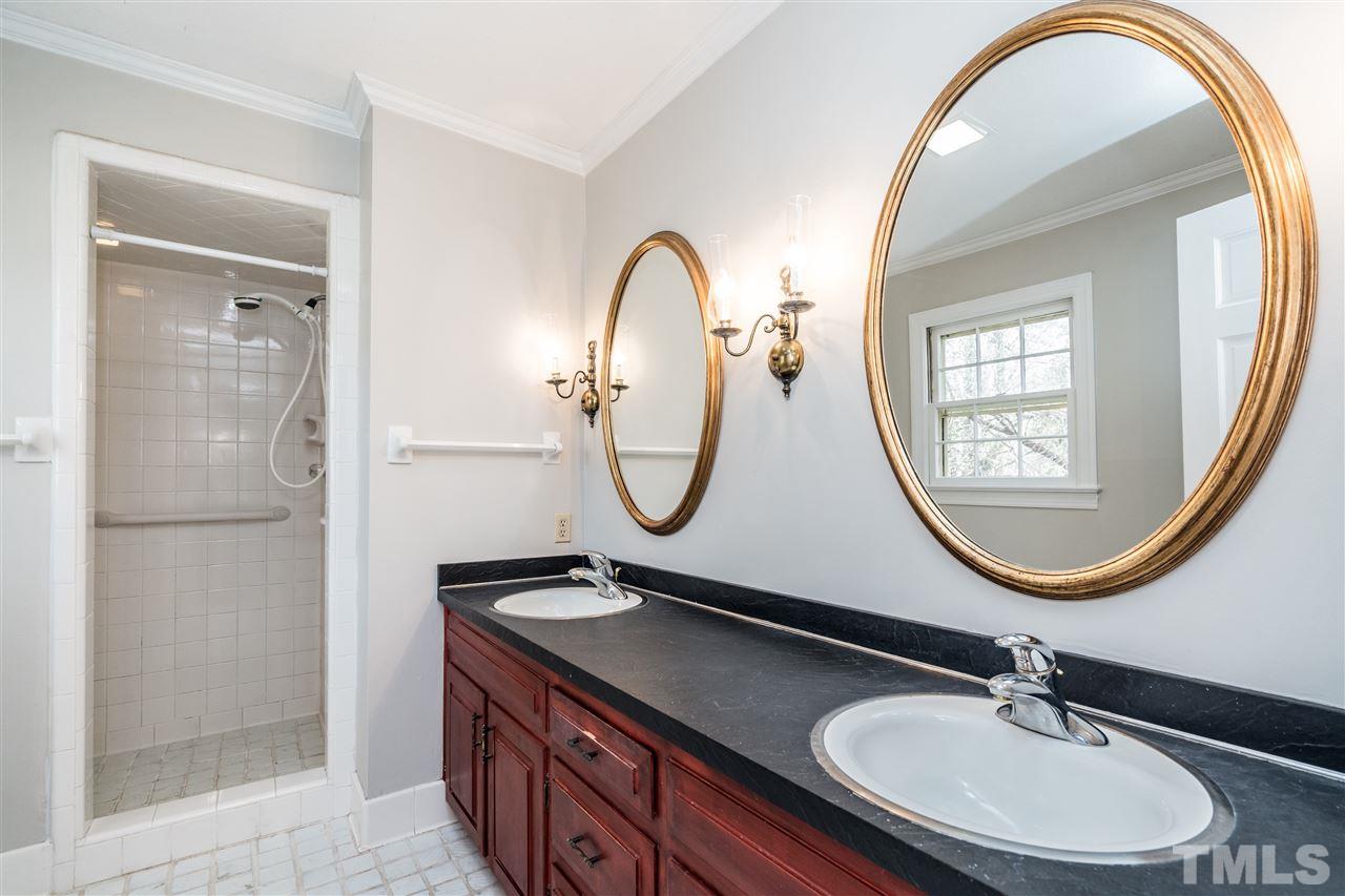 4516 Connell Drive Raleigh, NC 27612 - Photo 18 of 28 a bathroom with a sink and a mirror