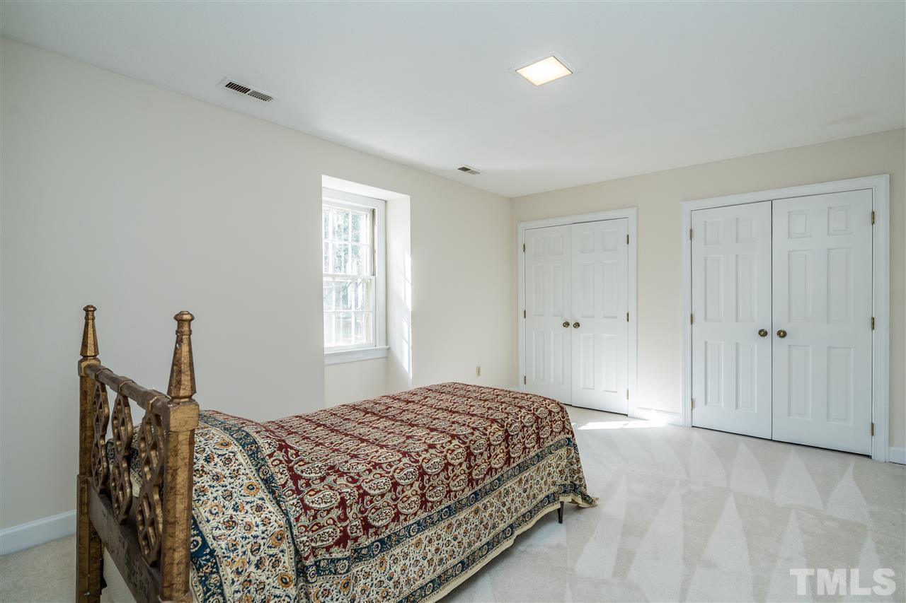 4516 Connell Drive Raleigh, NC 27612 - Photo 20 of 28 a bedroom with a bed and a window
