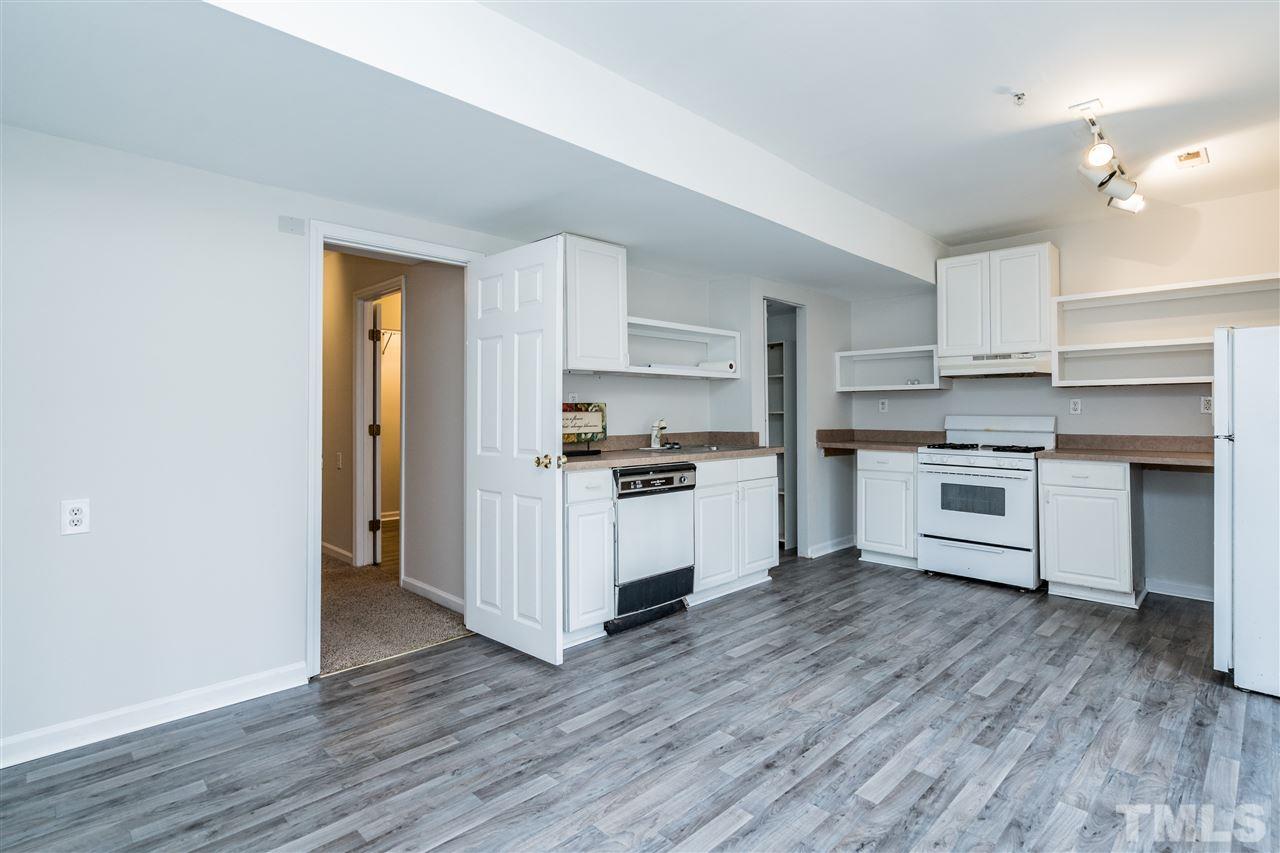 4516 Connell Drive Raleigh, NC 27612 - Photo 24 of 28 a kitchen with wooden floors and appliances
