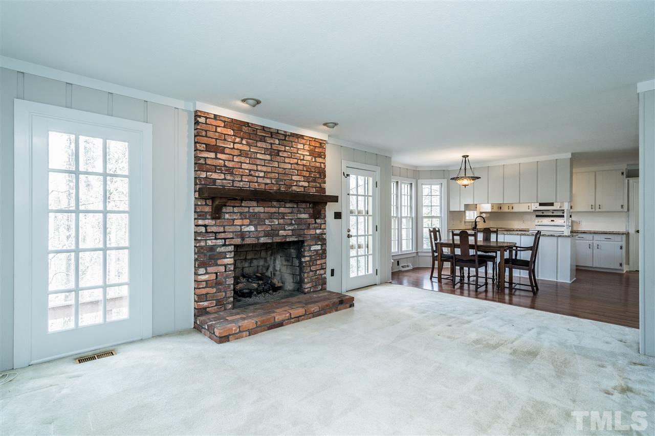 4516 Connell Drive Raleigh, NC 27612 - Photo 9 of 28 a living room with furniture and a fireplace