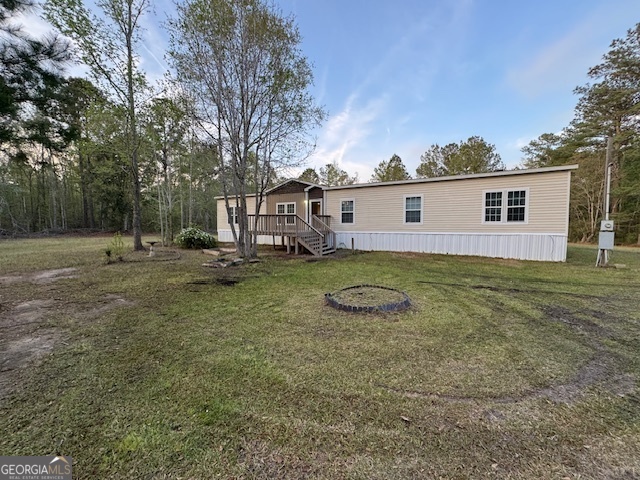 1275 Burnsed Road Pembroke, GA 31321 - Photo 1 of 1 a view of a house with backyard and trees