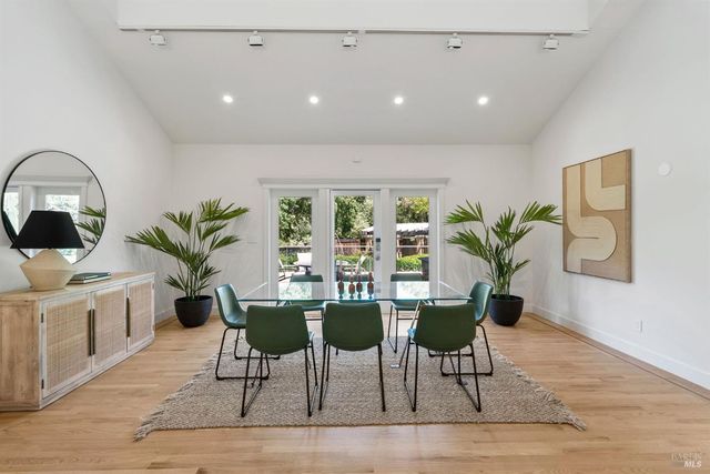 a kitchen with stainless steel appliances kitchen island granite countertop a refrigerator and a stove top oven