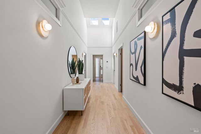 a bedroom with a bed and a painting on the wall