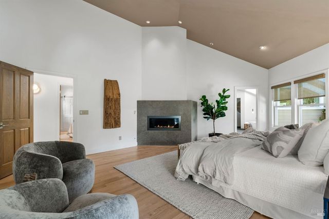 a bathroom with a granite countertop toilet sink and mirror