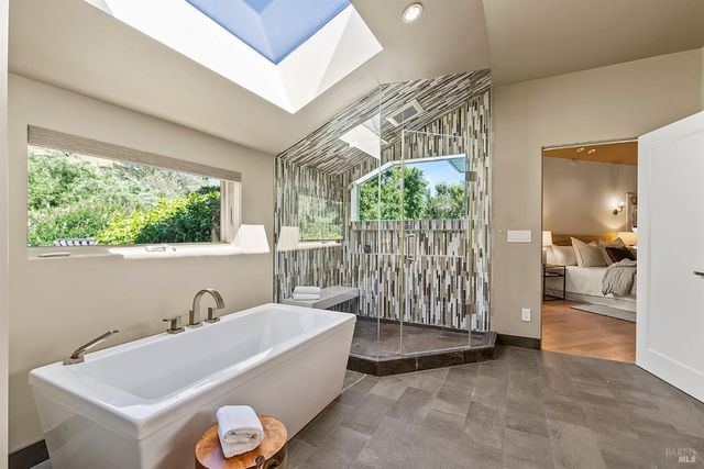 a bedroom with a large bed and a large mirror