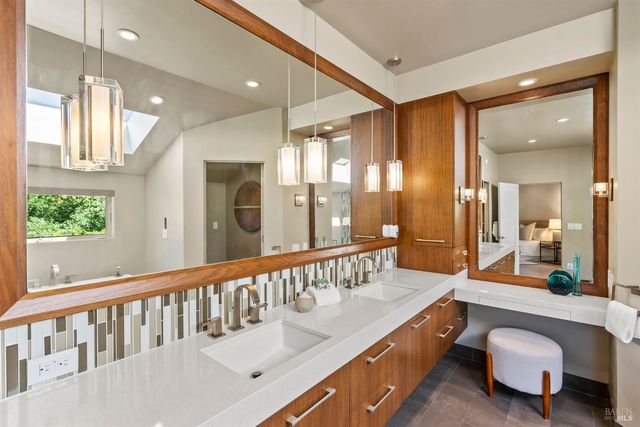 a bathroom with a bathtub sink and mirror