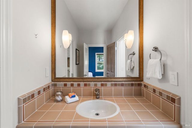 an aerial view of a house with a yard and garden